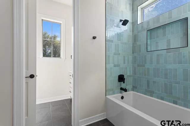 a bathroom with a bathtub and shower