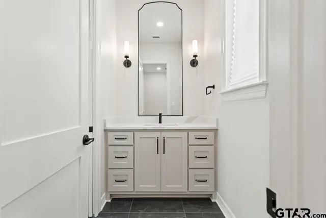 a bathroom with a sink a vanity and a mirror
