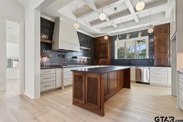 a large kitchen with stainless steel appliances granite countertop a stove a sink and a refrigerator