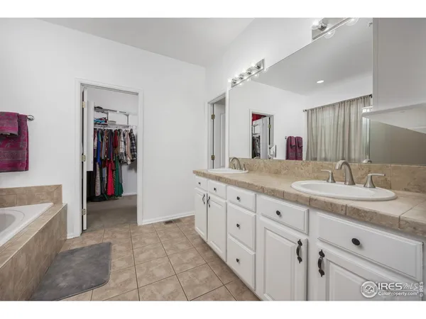 a bathroom with a sink vanity and a mirror