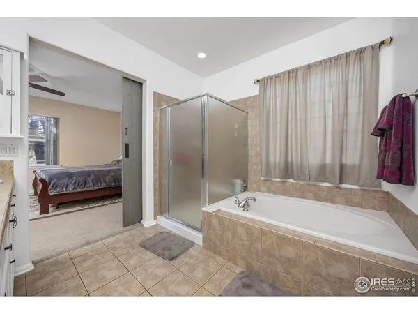 a bathroom with a tub a sink and a shower