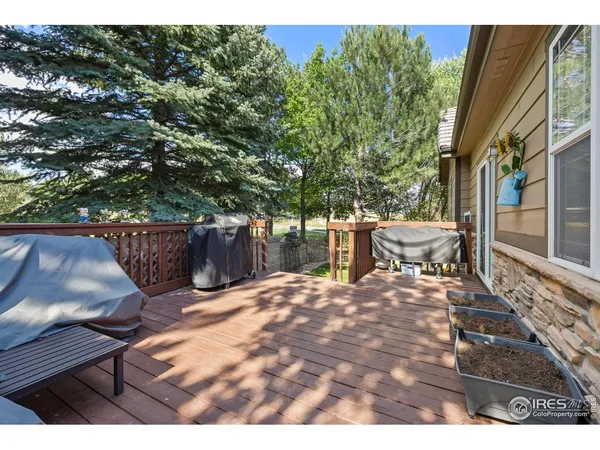 a view of backyard with deck and outdoor seating