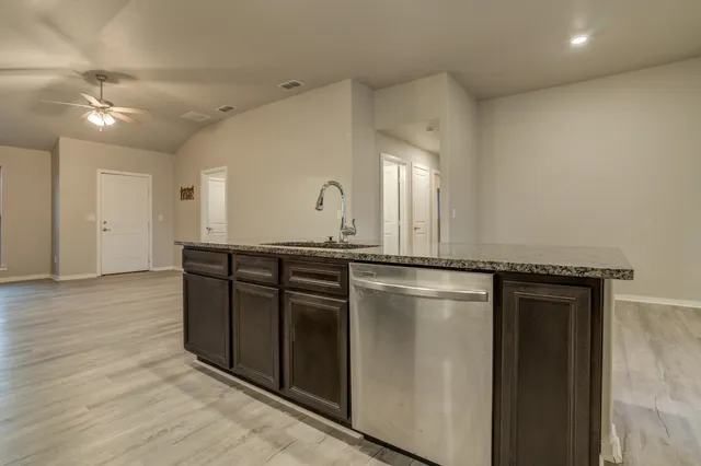 a kitchen with a refrigerator and a sink
