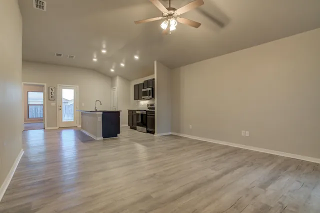a view of a kitchen with a sink and a window