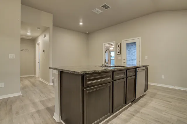 a kitchen with a sink and a refrigerator
