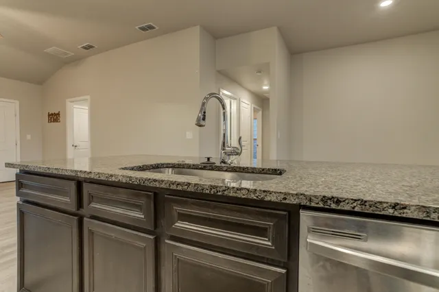 a view of a kitchen counter top space and stainless steel appliances