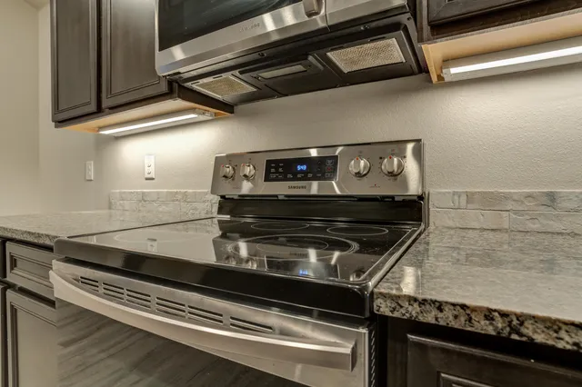 a stove top oven sitting inside of a kitchen