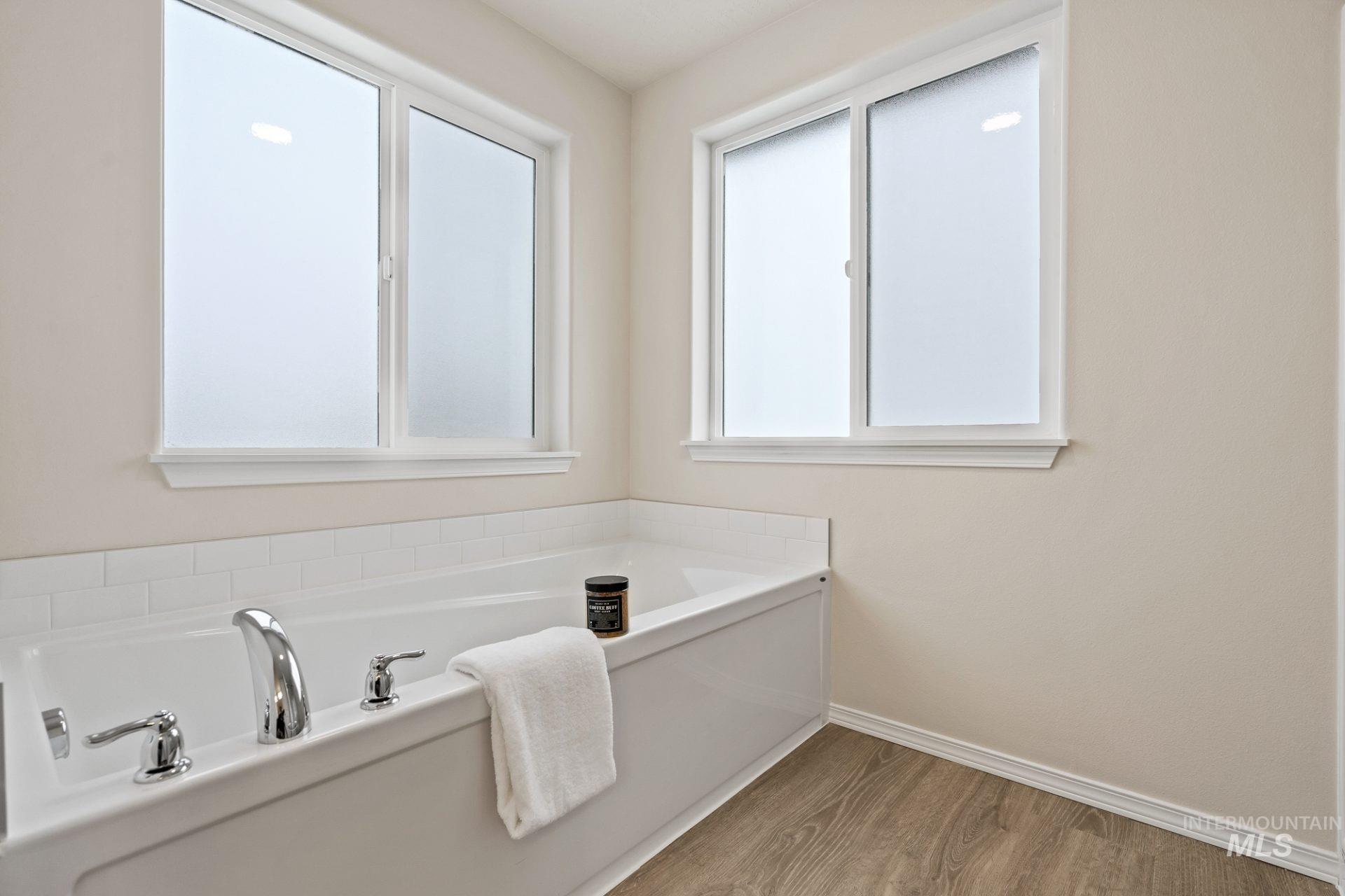 Tbd East Fitz Roy Street, Unit TALENT Kuna, ID 83634 - Photo 12 of 23 Full bathroom with healthy amount of natural light, a bath, and wood finished floors