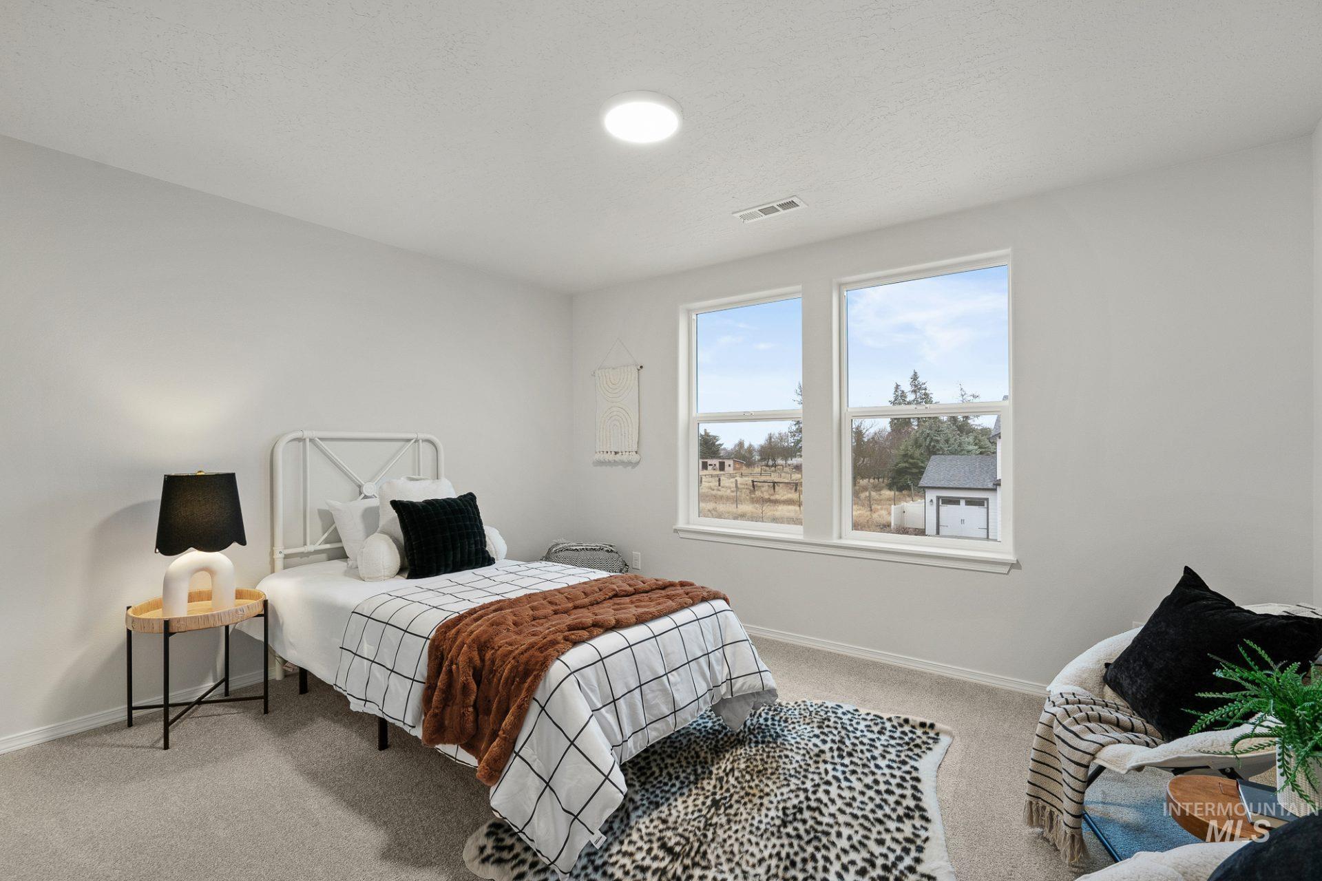 Tbd East Fitz Roy Street, Unit TALENT Kuna, ID 83634 - Photo 15 of 23 Bedroom featuring light colored carpet and a textured ceiling