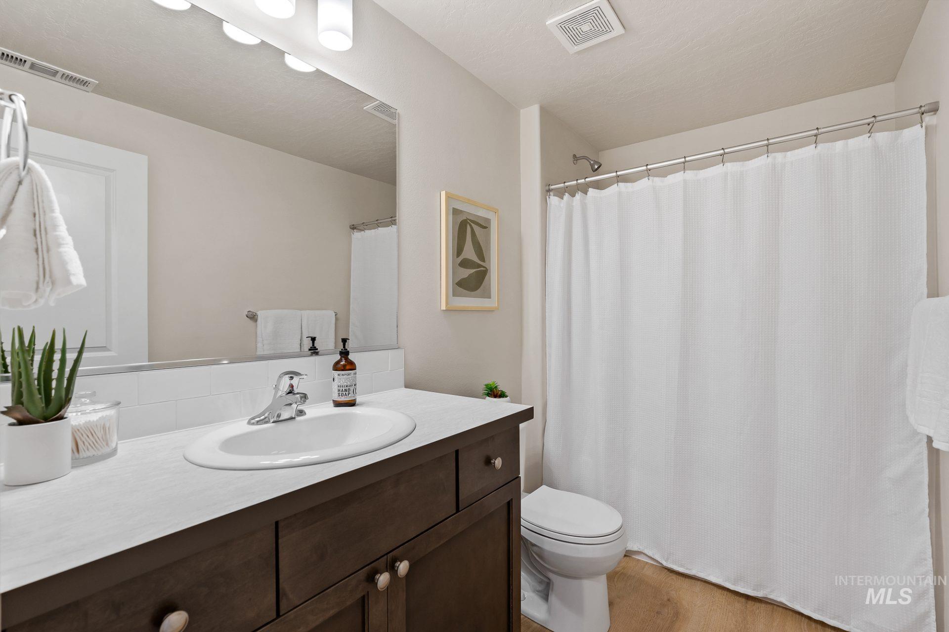Tbd East Fitz Roy Street, Unit TALENT Kuna, ID 83634 - Photo 21 of 23 Full bath featuring vanity, a shower with curtain, and light wood-style floors