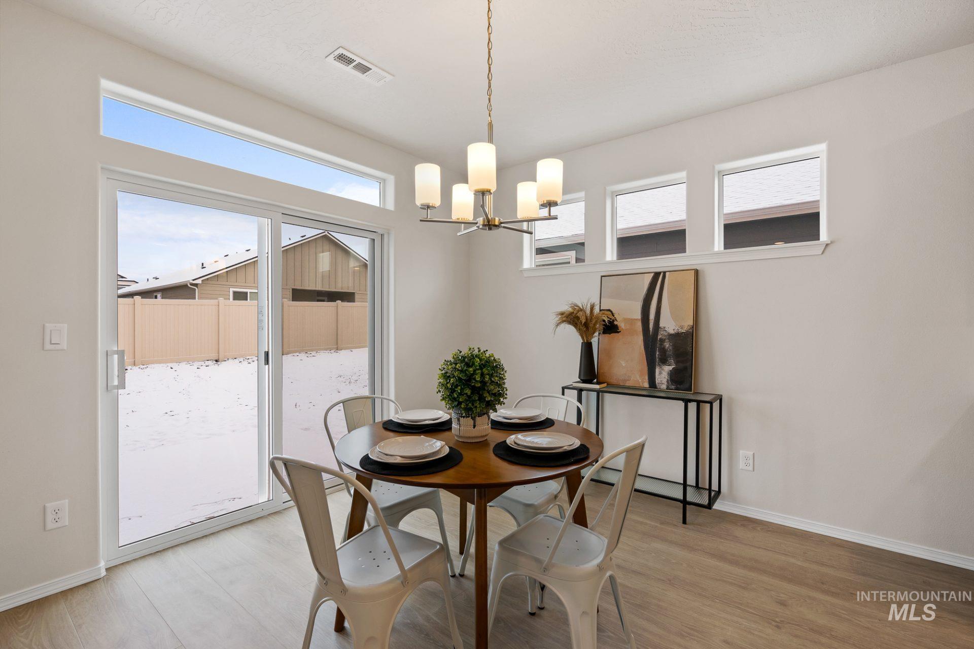 Tbd East Fitz Roy Street, Unit TALENT Kuna, ID 83634 - Photo 6 of 23 Dining space featuring a chandelier and light wood finished floors