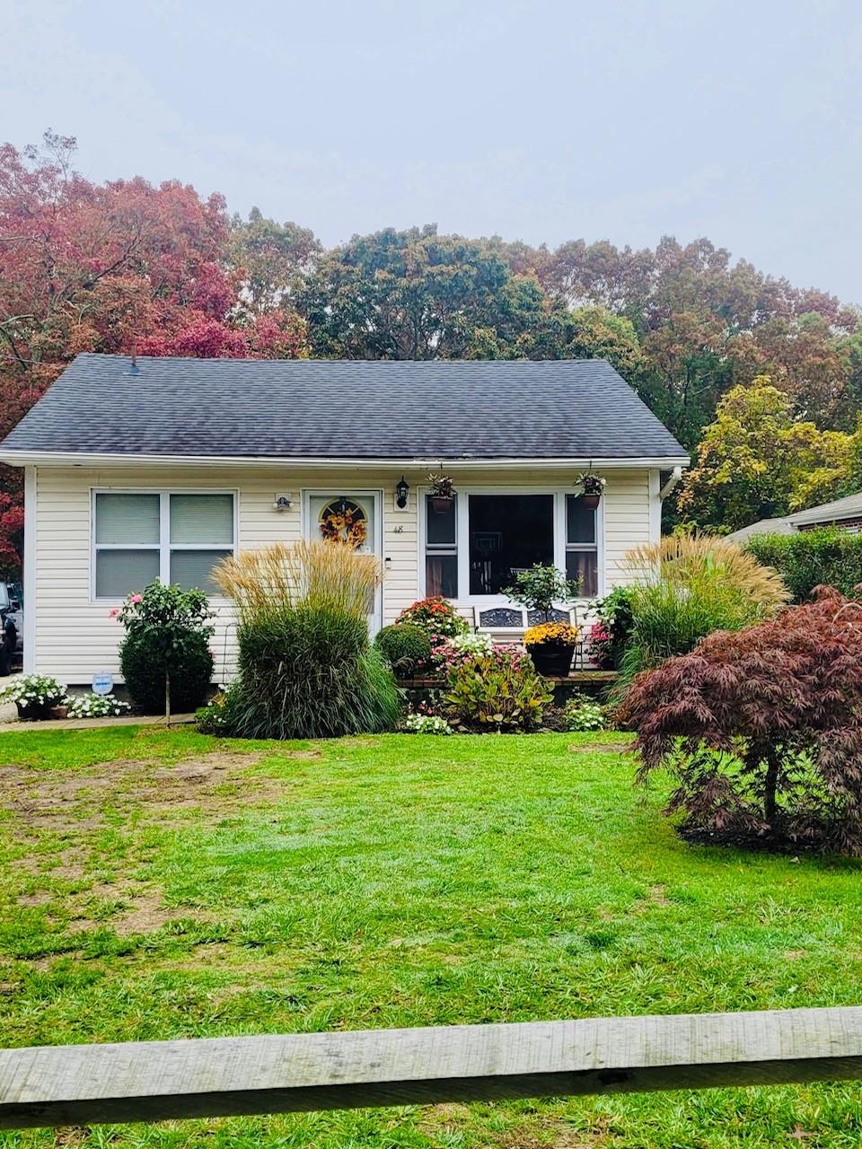 a view of a house with backyard sitting area and garden