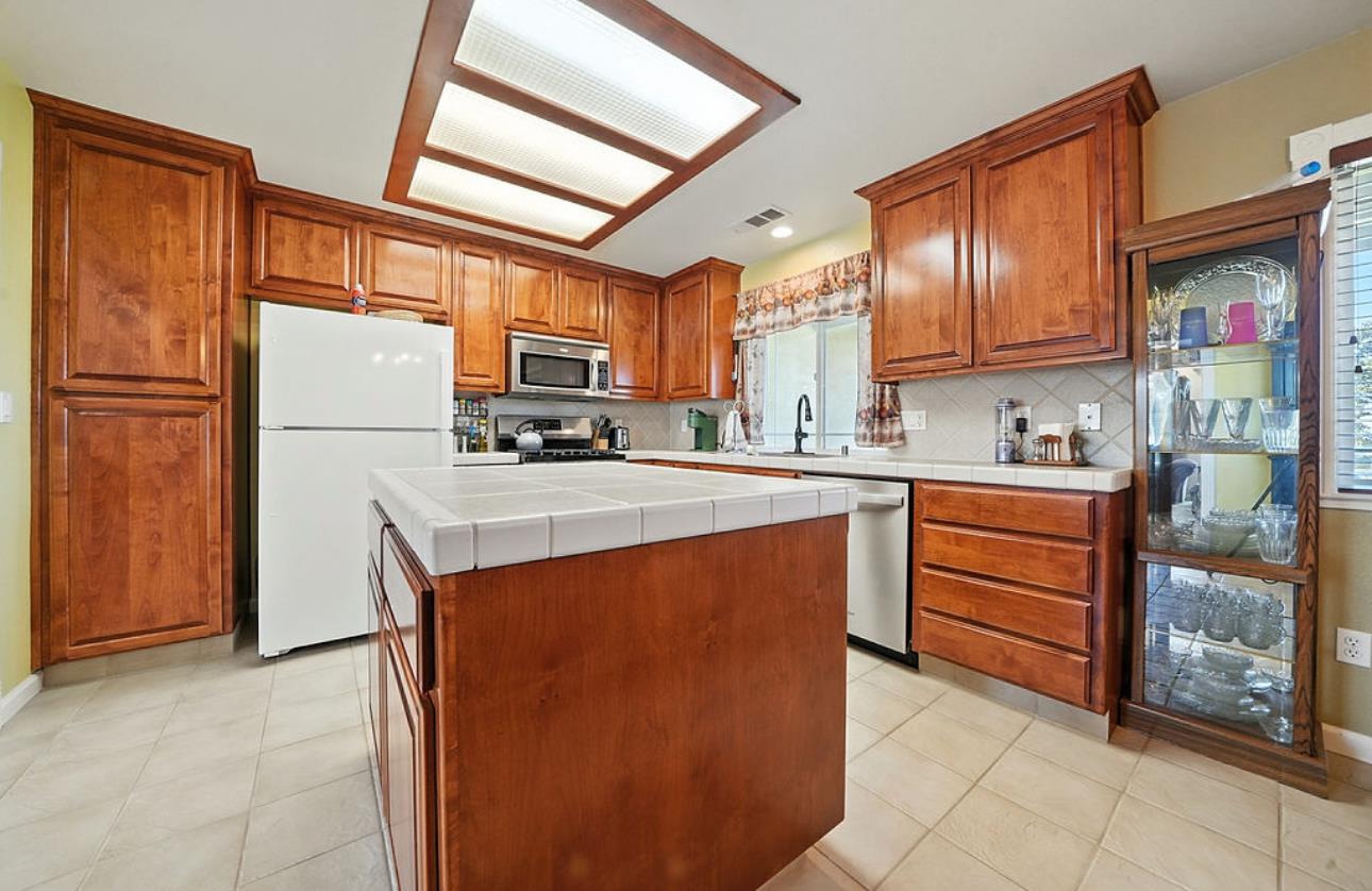 5825 Rippon Road Valley Springs, CA 95252 - Photo 15 of 45 a kitchen with stainless steel appliances a refrigerator sink and cabinets