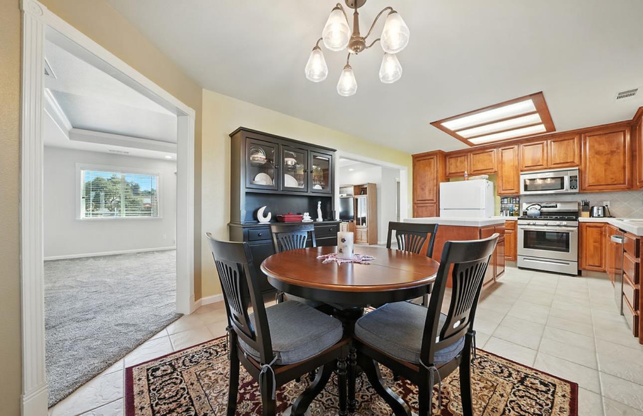 5825 Rippon Road Valley Springs, CA 95252 - Photo 21 of 45 a dining room with furniture a chandelier and wooden floor