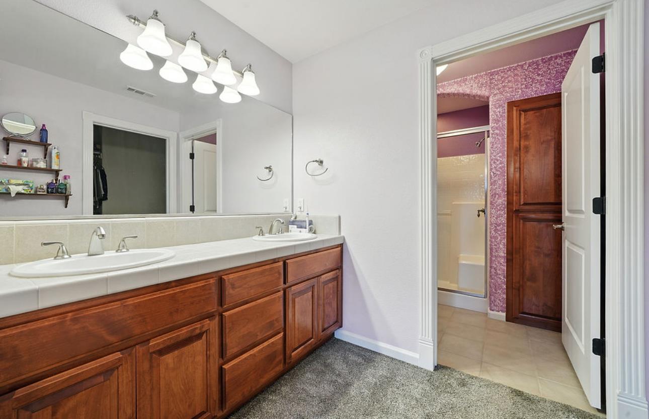 5825 Rippon Road Valley Springs, CA 95252 - Photo 26 of 45 a bathroom with a double vanity sink and a mirror