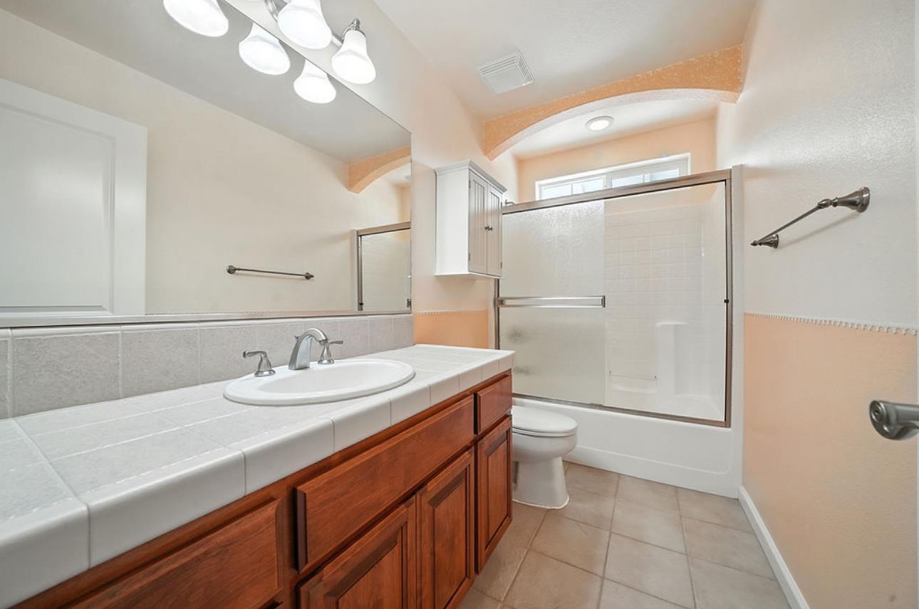5825 Rippon Road Valley Springs, CA 95252 - Photo 27 of 45 a bathroom with a sink a toilet a mirror and shower