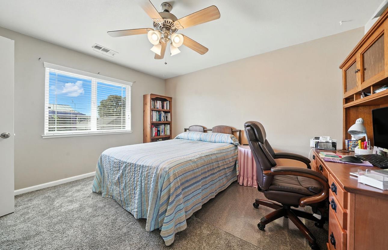 5825 Rippon Road Valley Springs, CA 95252 - Photo 31 of 45 a bedroom with a bed and a chandelier