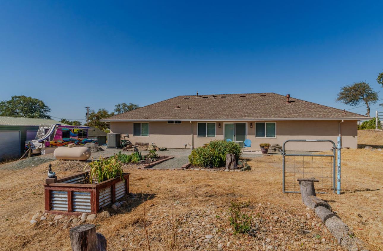5825 Rippon Road Valley Springs, CA 95252 - Photo 37 of 45 a view of a house with backyard sitting area and garden