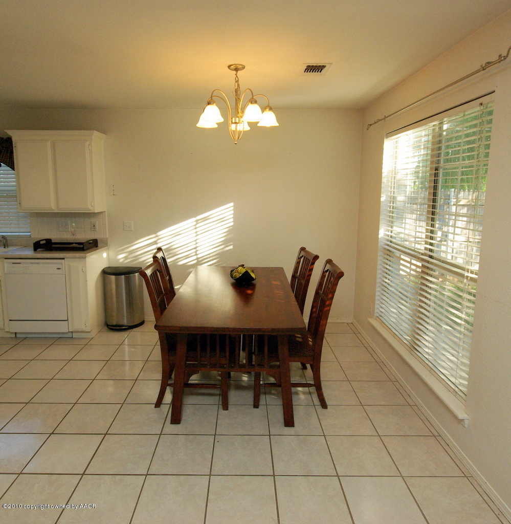 5200 Capulin Lane Amarillo, TX 79110 - Photo 3 of 8 a view of a dining room with furniture and chandelier