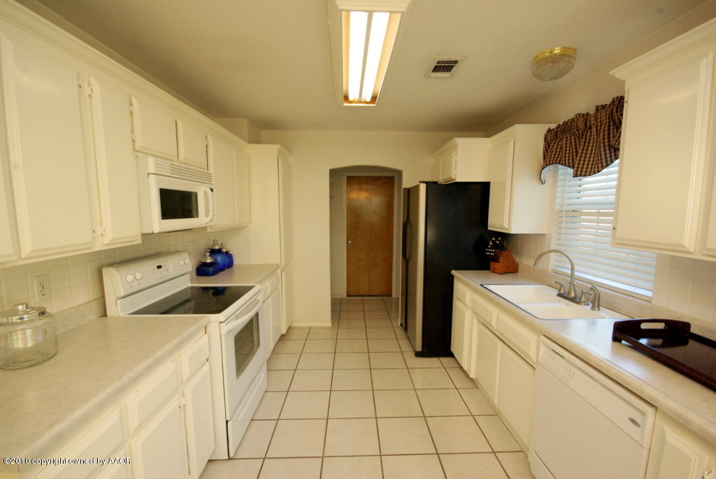 5200 Capulin Lane Amarillo, TX 79110 - Photo 4 of 8 a kitchen with a sink a refrigerator and a sink