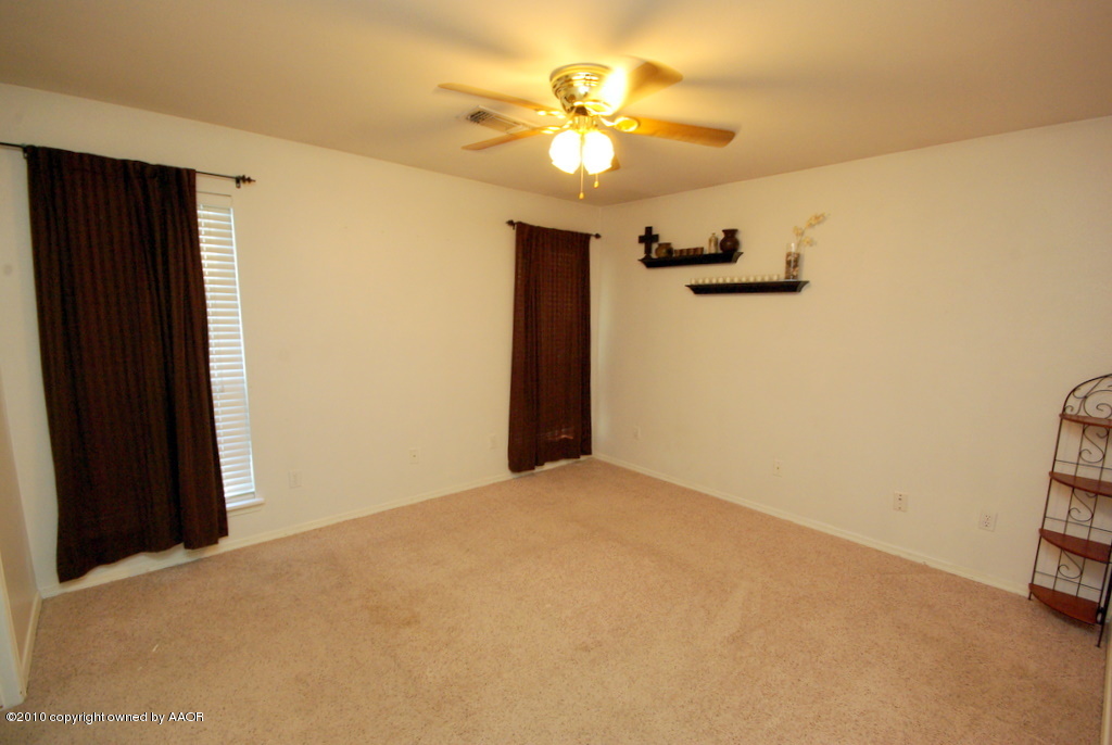 5200 Capulin Lane Amarillo, TX 79110 - Photo 5 of 8 a view of an empty room with a window