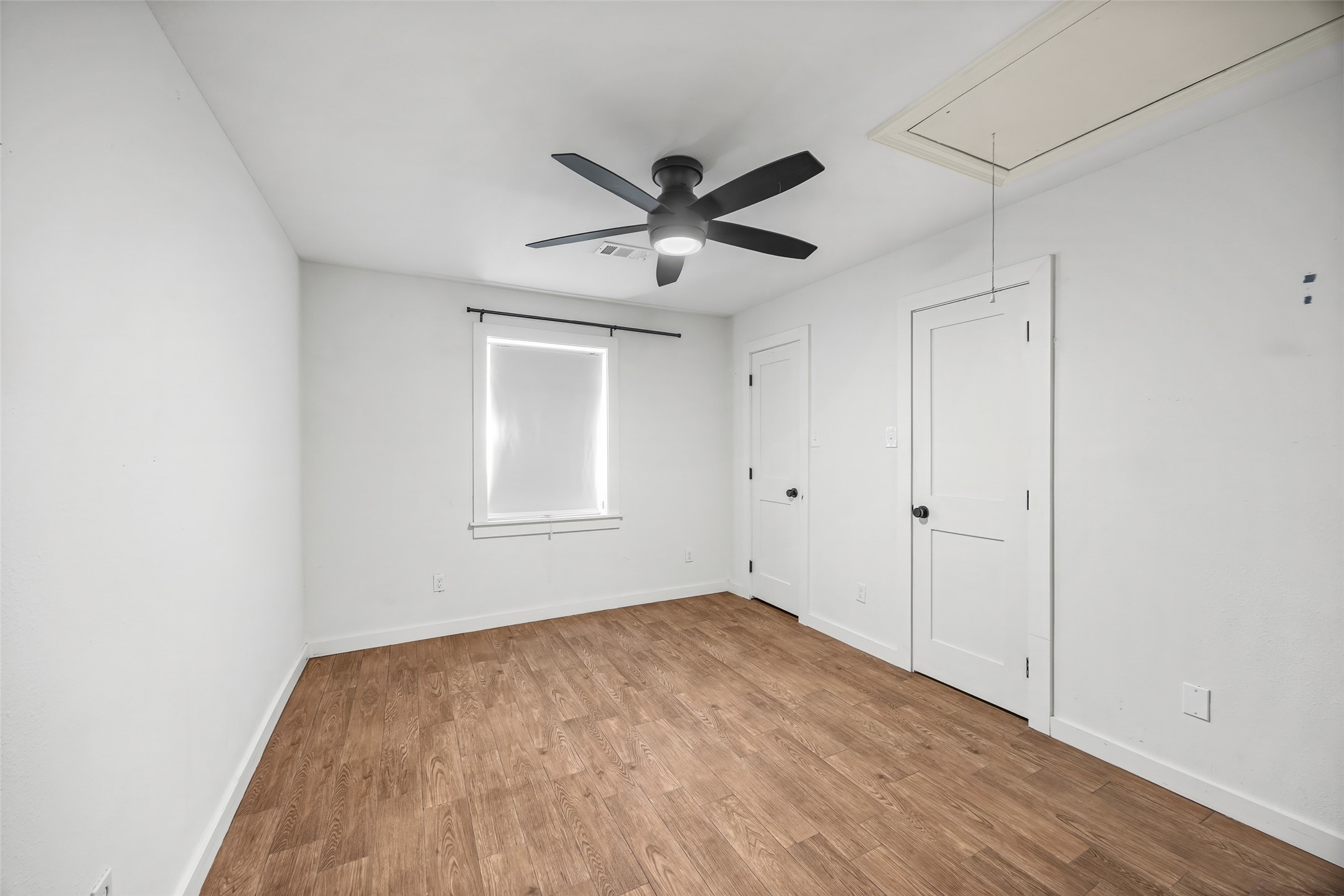 9715 Greenwillow Street Houston, TX 77096 - Photo 17 of 31 a view of a big room with wooden floor and a ceiling fan
