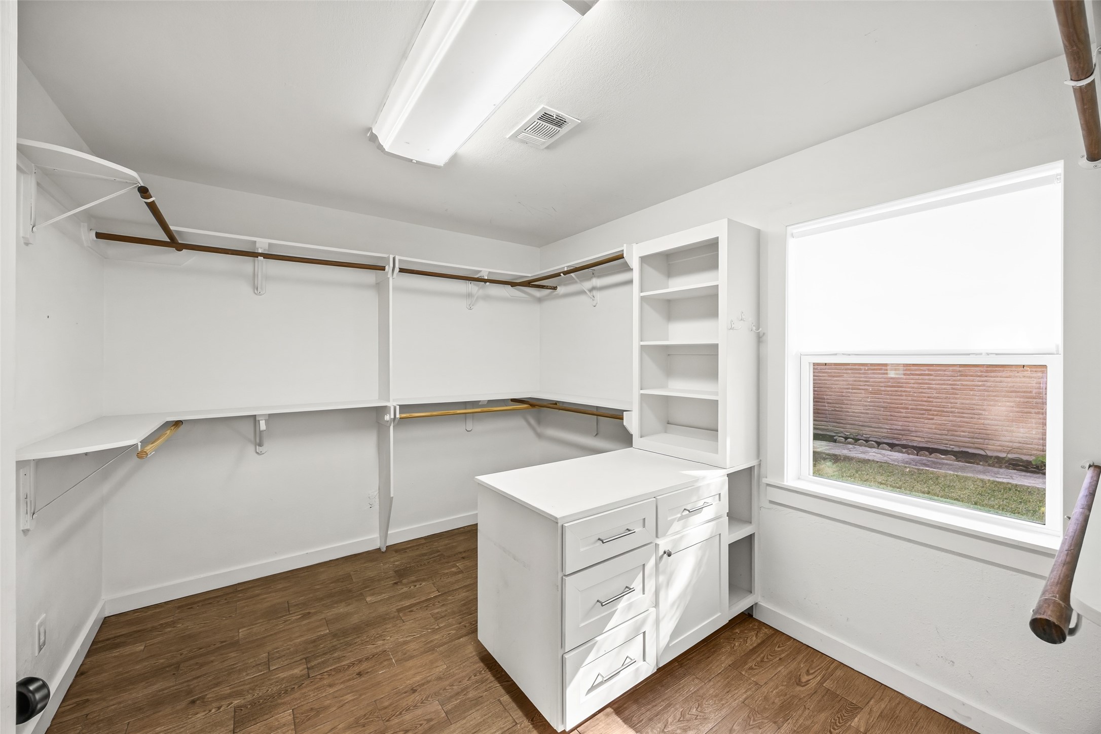 9715 Greenwillow Street Houston, TX 77096 - Photo 26 of 31 a view of walk in closet with empty racks