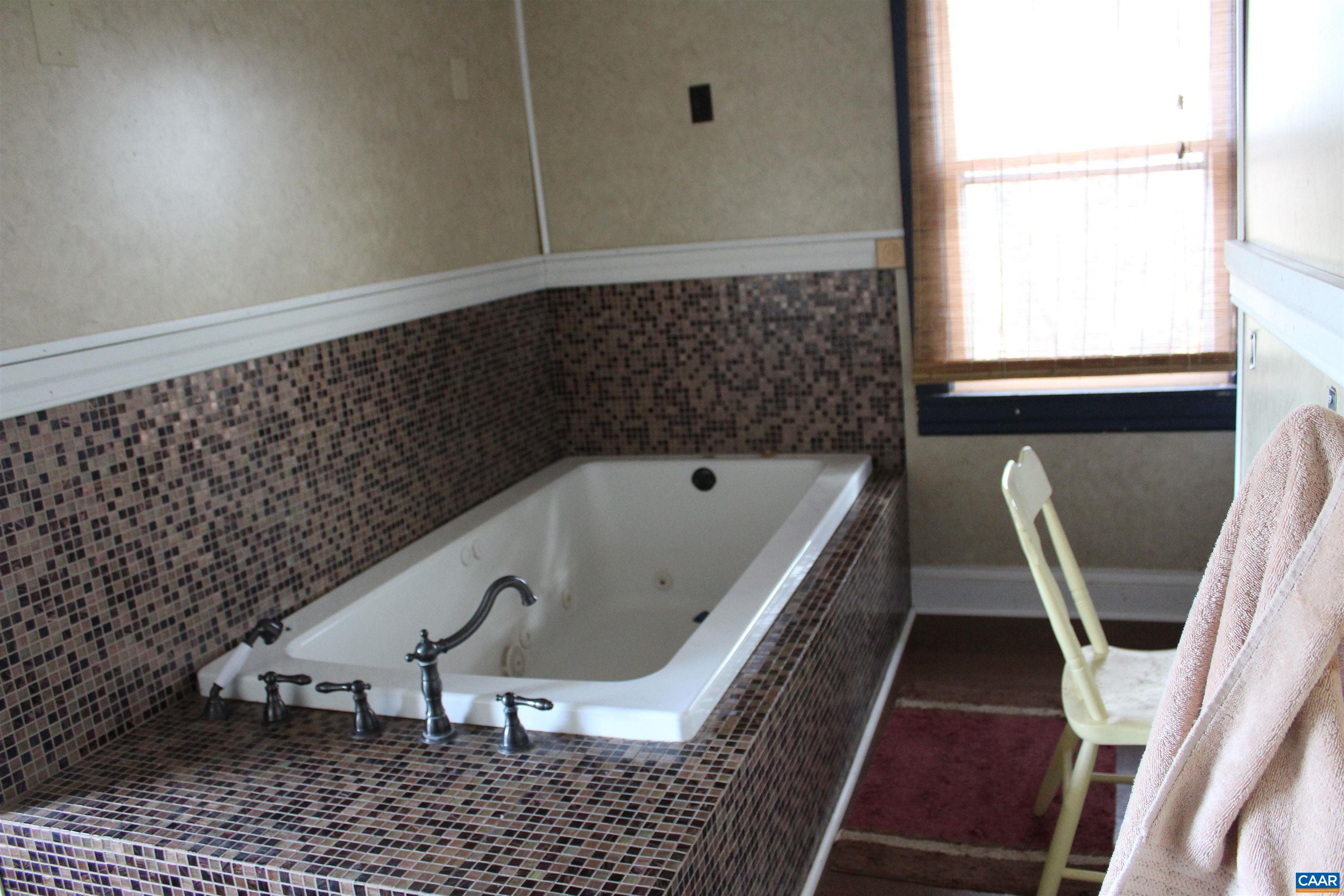 184 Flat Woods Road Amherst, VA 24521 - Photo 18 of 21 a bathroom with a bathtub and a window