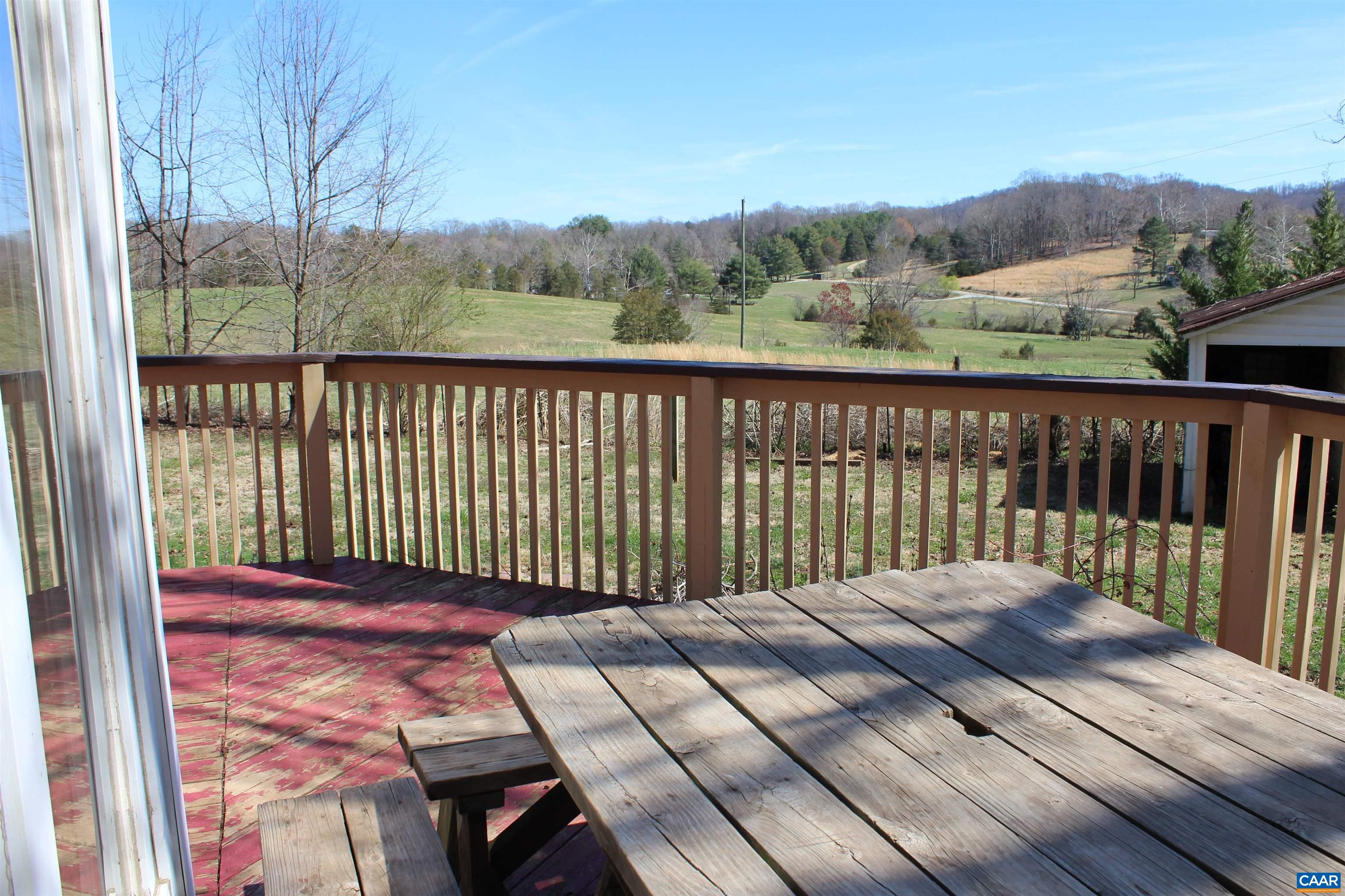 184 Flat Woods Road Amherst, VA 24521 - Photo 5 of 21 a view of a balcony with wooden floor and fence
