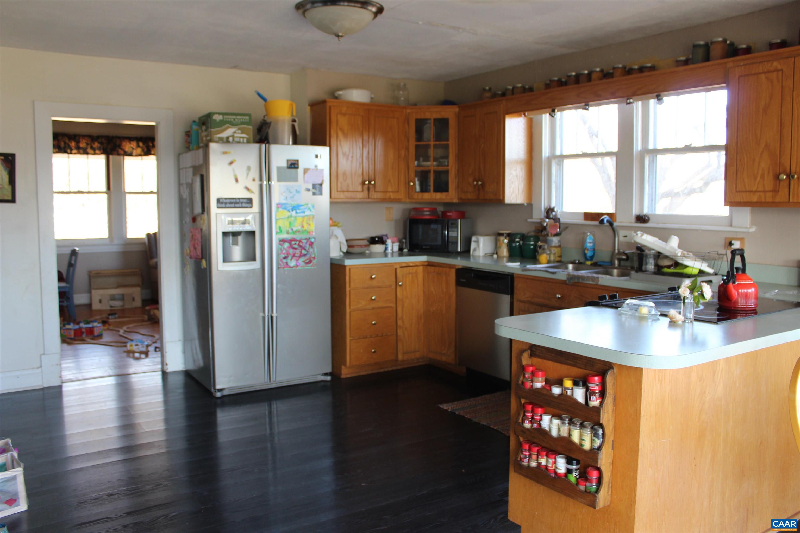 184 Flat Woods Road Amherst, VA 24521 - Photo 10 of 21 a kitchen with stainless steel appliances granite countertop a refrigerator a sink a stove and wooden floor