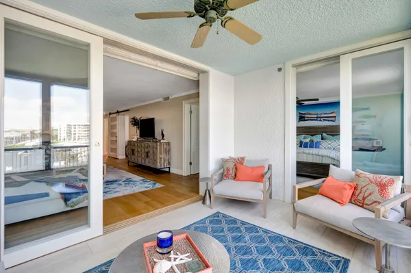 a living room with furniture and a floor to ceiling window