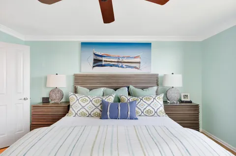 a view of a bedroom with furniture and wooden floor