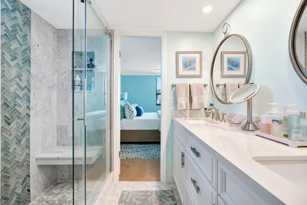 a spacious bathroom with a double vanity sink a mirror and a shower