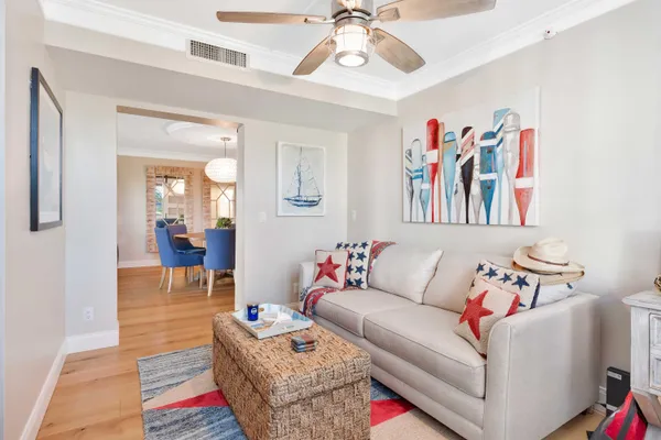 a living room with furniture and a painting on the wall
