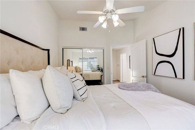 a bedroom with a bed and a large mirror