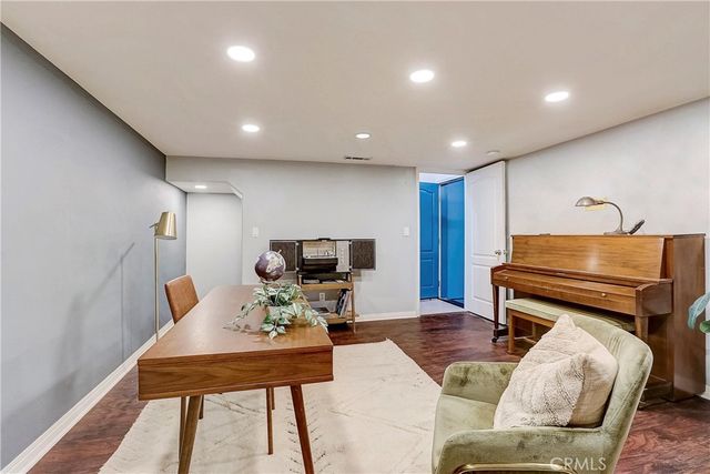 front view of a house with swimming pool and sitting area