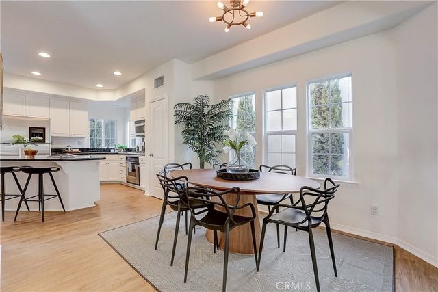 a view of a dining room with furniture and a large window