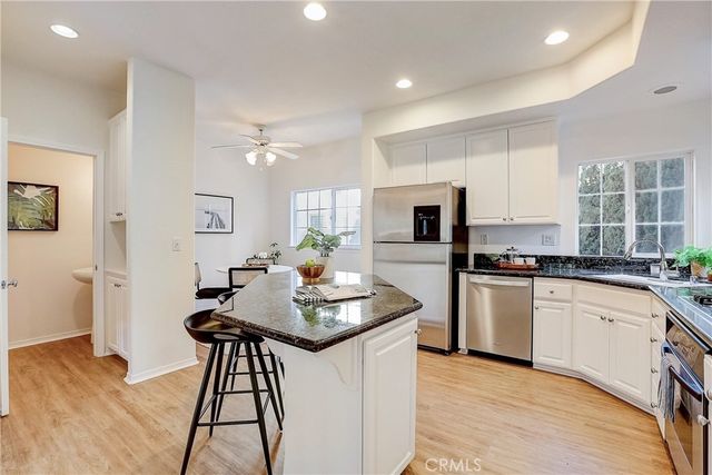 a kitchen with sink cabinets and wooden floor
