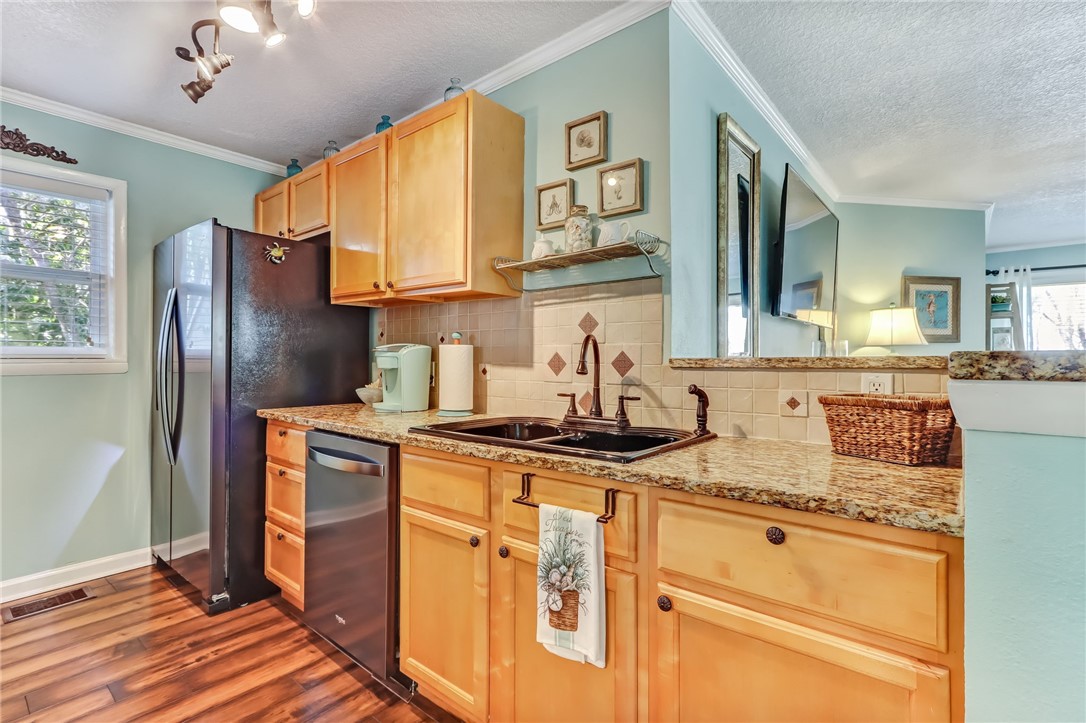 97253 Pirates Point Road Yulee, FL 32097 - Photo 13 of 34 a kitchen with stainless steel appliances granite countertop a sink stove and refrigerator