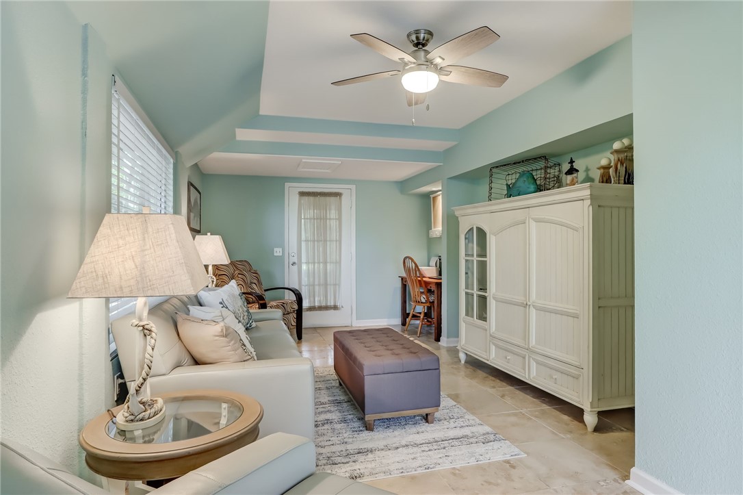 97253 Pirates Point Road Yulee, FL 32097 - Photo 20 of 34 a living room with furniture and a chandelier