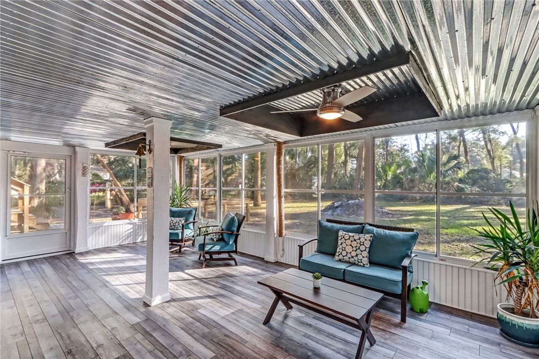 97253 Pirates Point Road Yulee, FL 32097 - Photo 23 of 34 a roof deck with table and chairs and wooden floor