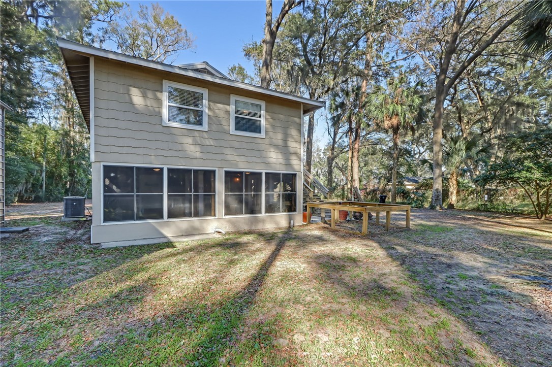 97253 Pirates Point Road Yulee, FL 32097 - Photo 27 of 34 a front view of a house with a yard and garage