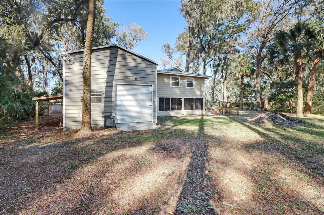 97253 Pirates Point Road Yulee, FL 32097 - Photo 28 of 34 a view of a house with a yard