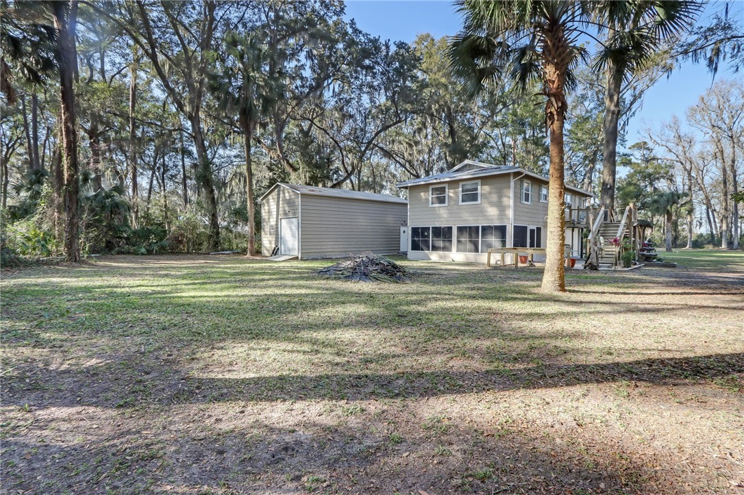97253 Pirates Point Road Yulee, FL 32097 - Photo 29 of 34 a view of a house with a big yard