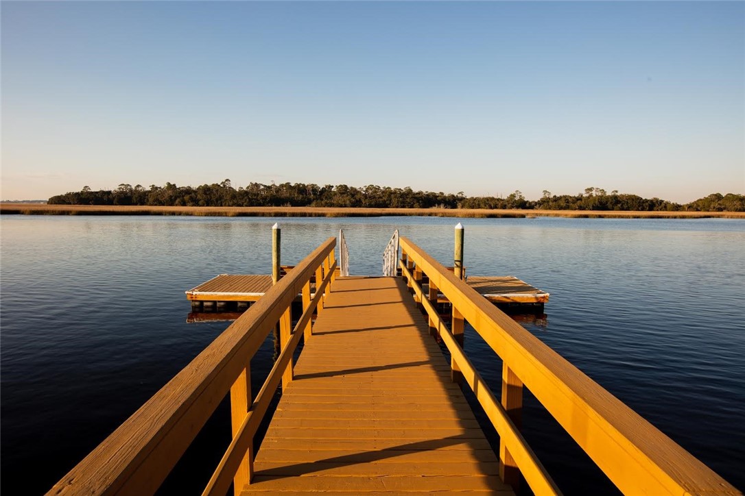 97253 Pirates Point Road Yulee, FL 32097 - Photo 31 of 34 a wooden pier with boats in a lake