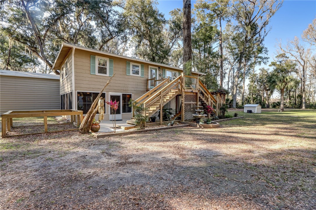 97253 Pirates Point Road Yulee, FL 32097 - Photo 5 of 34 a view of a house with a backyard