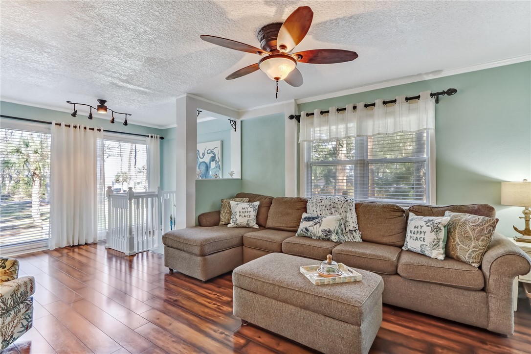 97253 Pirates Point Road Yulee, FL 32097 - Photo 9 of 34 a living room with furniture and a large window with wooden floor