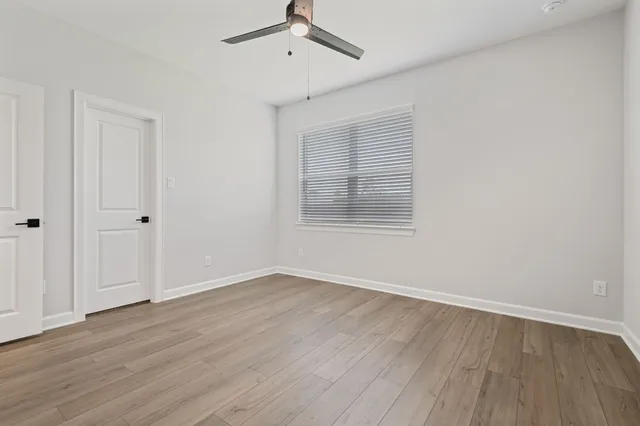 wooden floor in an empty room with a window