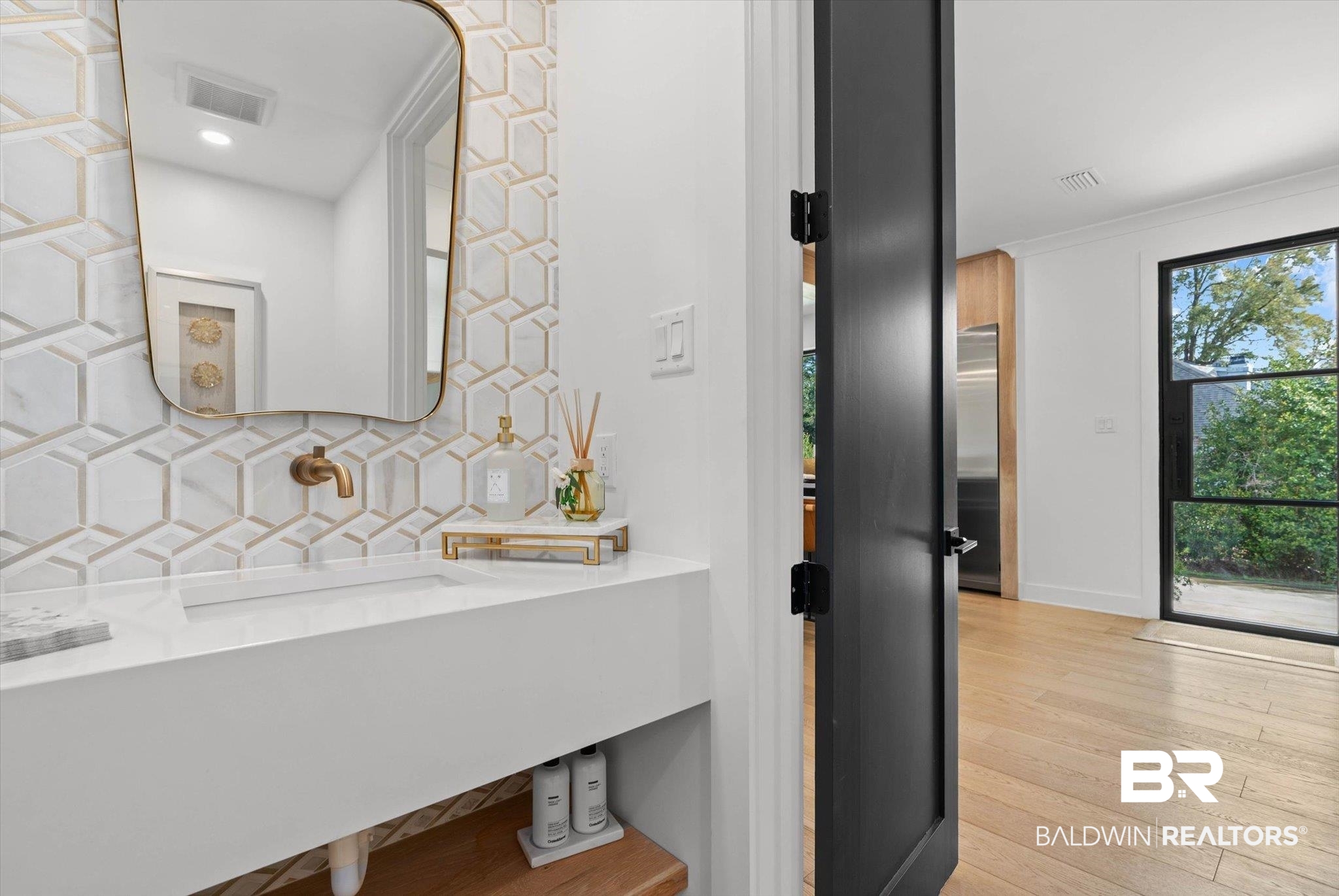 69 Jordan Lane Mobile, AL 36608 - Photo 12 of 57 Half bath with decorative backsplash, vanity, and light wood-type flooring