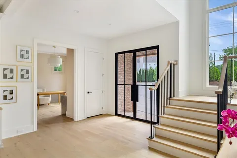 a view of a livingroom with wooden floor and stairs